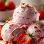 Strawberry Cheesecake Protein Balls on a plate garnished with fresh strawberries