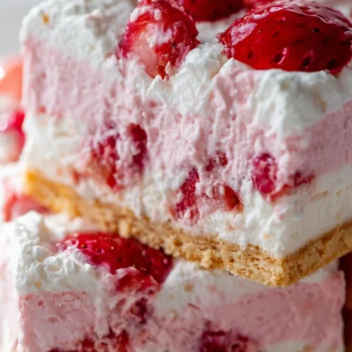 Delicious strawberry dessert topped with whipped cream and fresh berries.