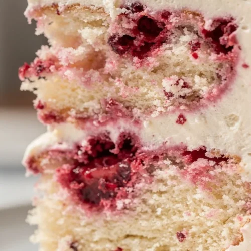 Strawberry lemonade cake topped with creamy lemon buttercream frosting