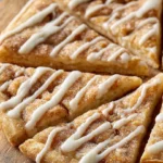 Sweet cinnamon swirl pizza topped with icing and cinnamon sugar