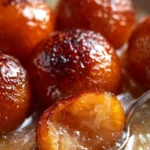 Delicious homemade Gulab Jamun served with syrup in a traditional bowl