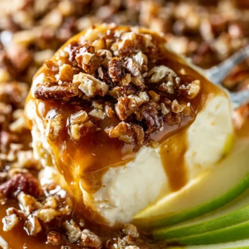 Delicious caramel apple cheesecake dip served with apple slices.