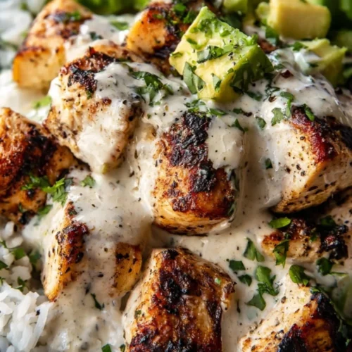 Delicious Coconut Chicken Rice Bowl garnished with fresh herbs and vegetables