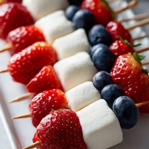 Colorful fruit kabobs with a variety of fresh fruits on skewers.