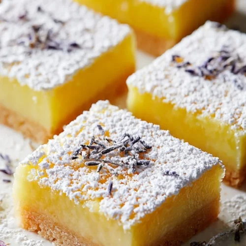 Lavender lemon bars topped with lavender petals and lemon zest
