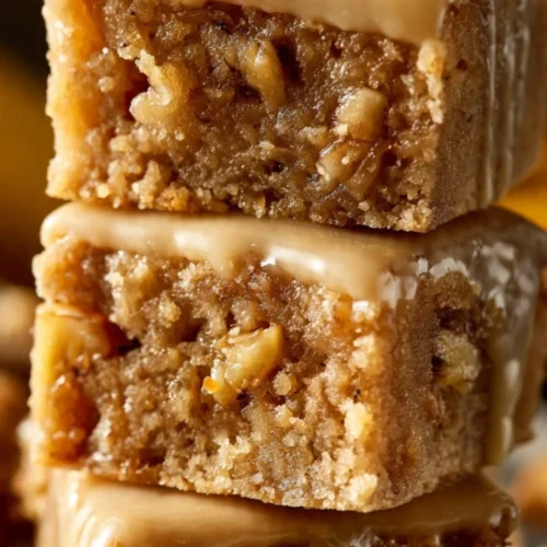 Delicious maple glazed apple blondies with fresh apples on a plate