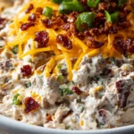 Creamy Million Dollar Crack Dip served in a bowl with crackers and veggies