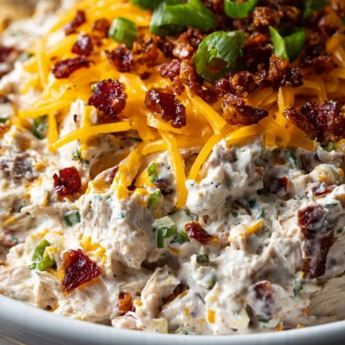 Creamy Million Dollar Crack Dip served in a bowl with crackers and veggies