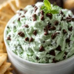No-bake mint chocolate chip dip served in a bowl with chocolate chips and mint leaves