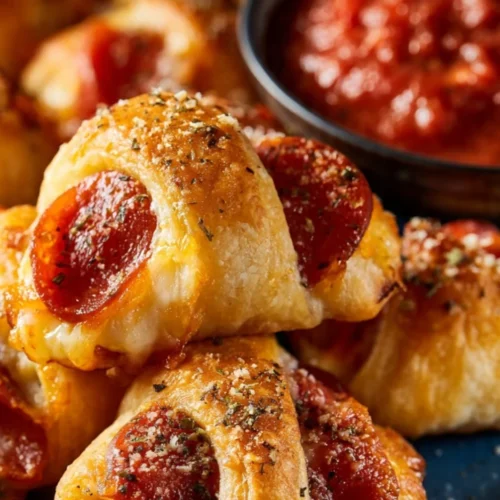Delicious pizza stuffed crescent rolls ready to serve as tasty pizza rolls.