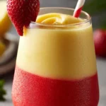Strawberry Pina Colada cocktail garnished with fresh strawberries and pineapple