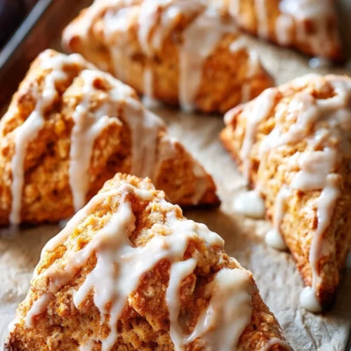 Freshly baked pumpkin scones with spices, perfect for autumn gatherings.