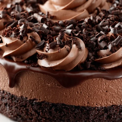 Delicious slice of triple chocolate cheesecake topped with chocolate shavings