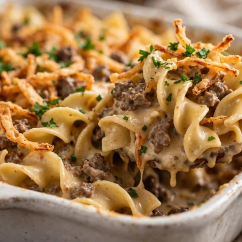 Delicious French Onion Beef Casserole topped with melted cheese and caramelized onions
