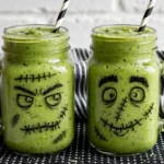 Colorful Halloween Monster Smoothies in spooky glasses.